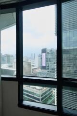 Bedroom with large window and city view