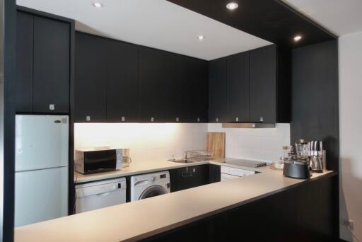 Modern kitchen with black cabinetry and appliances