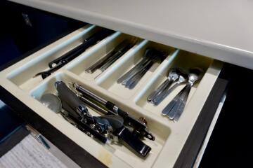 Open kitchen drawer with utensils