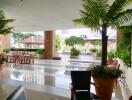 Outdoor lounge area with tables, chairs, and potted plants