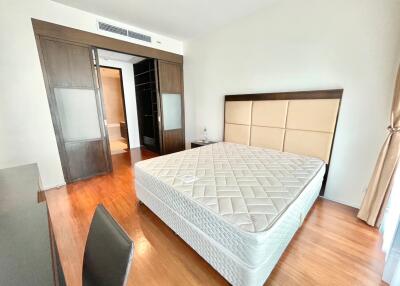 Spacious master bedroom with bed, window, and wardrobe