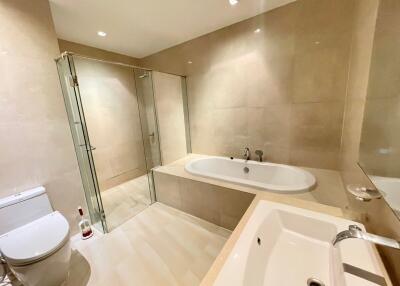 Modern bathroom with bathtub, shower, toilet, and sink