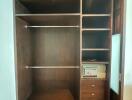 Wooden built-in wardrobe with open shelves and drawers