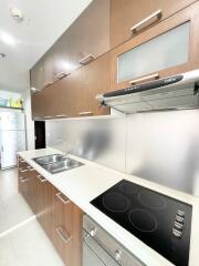 Modern kitchen with wooden cabinets and stainless steel appliances