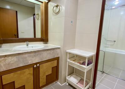 Modern bathroom with sink, mirror, storage and shower area