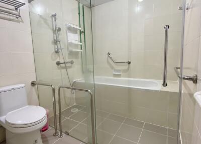 Modern bathroom with glass-enclosed bathtub and shower