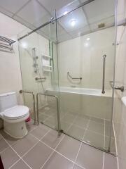 Modern bathroom with glass-enclosed bathtub and shower