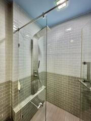 Modern bathroom with glass shower enclosure and subway tile walls