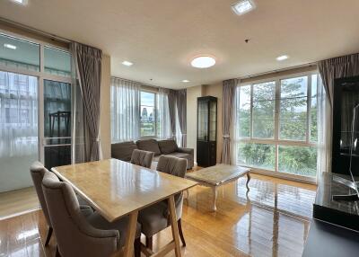 Spacious living room with large windows and modern furniture