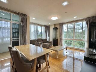 Spacious living room with large windows and modern furniture