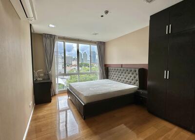 Modern bedroom with large window and city view