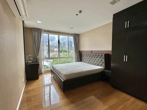 Modern bedroom with large window and city view