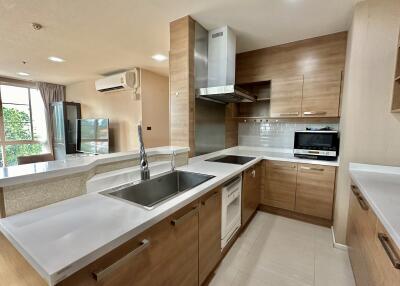 Modern kitchen with wooden cabinets and stainless steel appliances