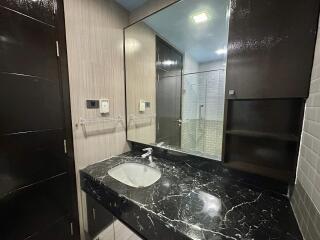 Modern bathroom with black marble countertop