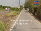 Narrow road with a real estate sign