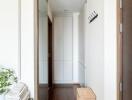 Clean and modern hallway with wooden flooring and a storage basket