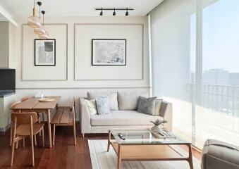 Modern living room with dining area, natural light, and contemporary furniture