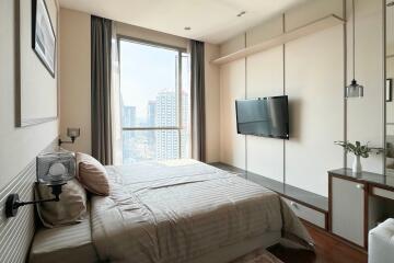 Modern bedroom with large window and city view