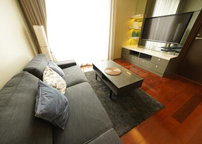 Modern living room with grey sofa and wall-mounted TV