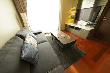 Modern living room with grey sofa and wall-mounted TV