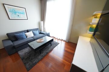 Modern living room with couch, coffee table, and entertainment unit