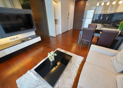 Modern living room with wooden flooring and dining area