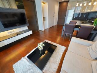 Modern living room with wooden flooring and dining area