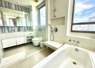 Modern bathroom with large window and city view