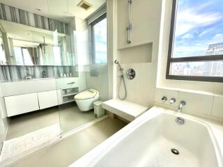 Modern bathroom with large window and city view