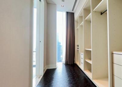 Spacious walk-in closet with built-in shelving and drawers.