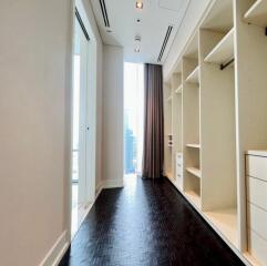 Spacious walk-in closet with built-in shelving and drawers.