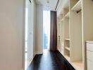 Spacious walk-in closet with built-in shelving and drawers.