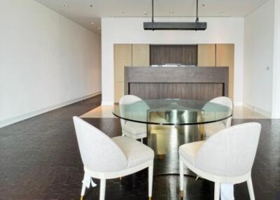 Modern dining room with glass table and upholstered chairs