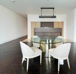 Modern dining room with glass table and upholstered chairs