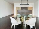 Modern dining room with glass table and upholstered chairs