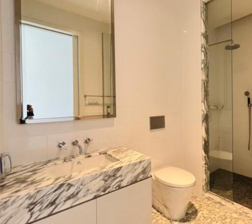 Modern bathroom with marble vanity and walk-in shower