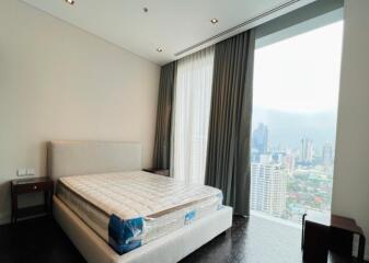 Bedroom with large window and city view