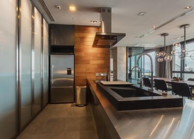 Modern kitchen with stainless steel appliances and elegant dining area