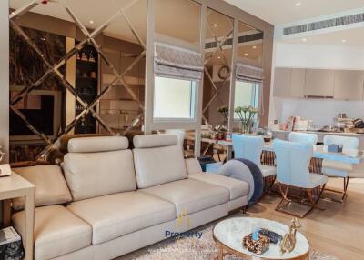 Modern living room with beige leather sofa and dining area