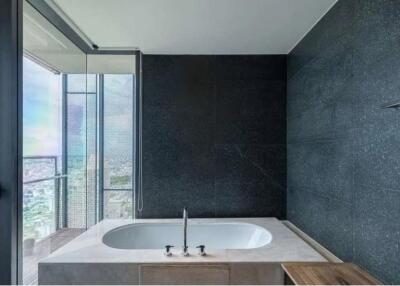 Modern bathroom with large window and soaking tub