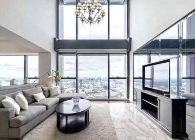 Spacious living room with large windows and city view