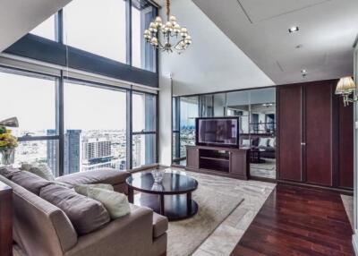 Spacious living room with large windows and city view