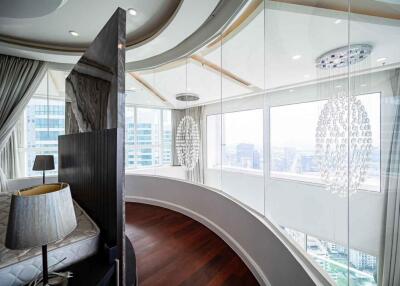 Modern bedroom with floor-to-ceiling windows and city view