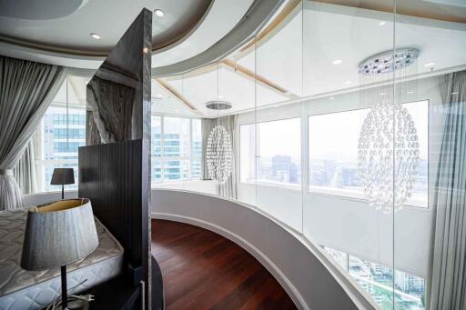 Modern bedroom with floor-to-ceiling windows and city view