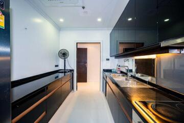 Modern kitchen with black cabinets and built-in appliances