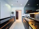 Modern kitchen with black cabinets and built-in appliances