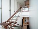 Modern staircase with glass railing and wooden steps