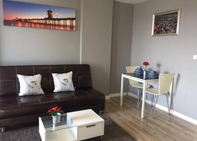 Modern living room with a sofa, coffee table, and dining area