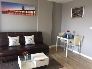 Modern living room with a sofa, coffee table, and dining area