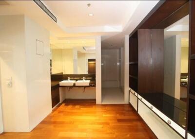 Modern bathroom with large mirrors and wooden flooring